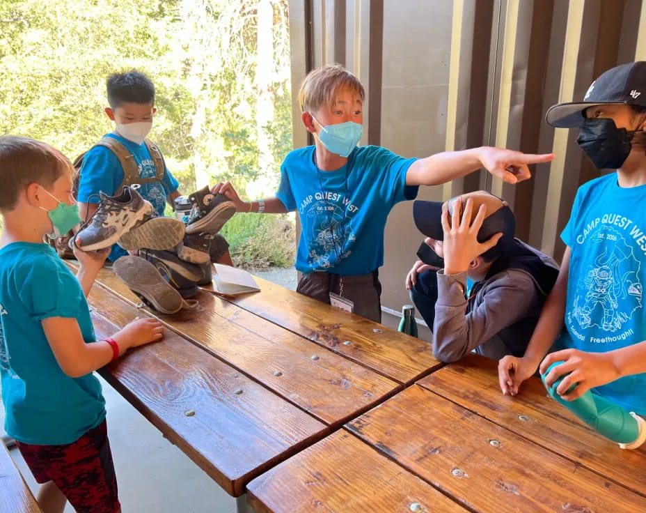 a group of kids playing with a turtle on a wooden table