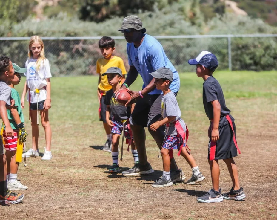 a group of kids playing football