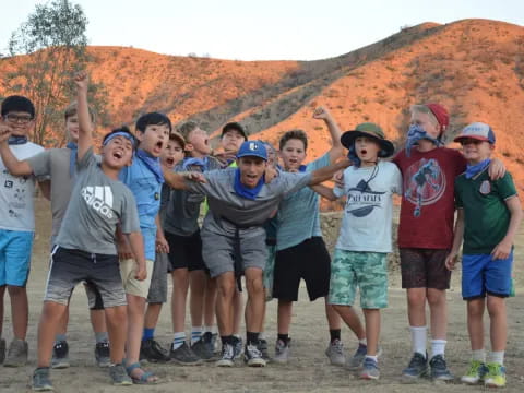 a group of people posing for a photo in front of a canyon