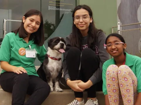 a group of people sitting on a bench with a dog