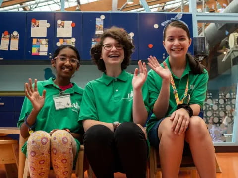 a group of women in green shirts