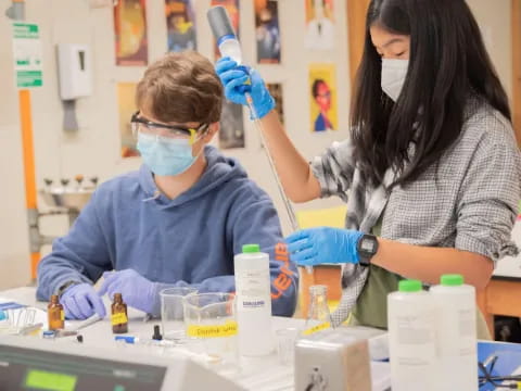 a man and a woman wearing safety goggles and gloves