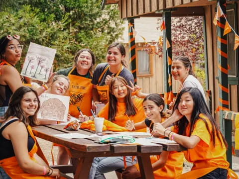 a group of women in orange shirts