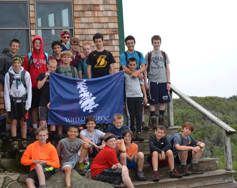 a group of people posing for a photo with a flag