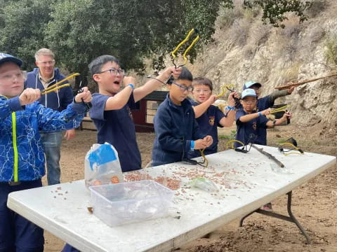 a group of people holding a fishing pole and a fish