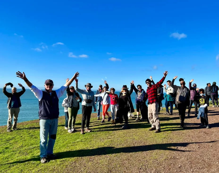 a group of people standing on a field with their arms raised