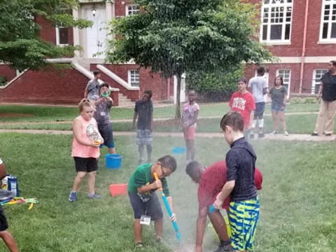 a group of children playing in a yard