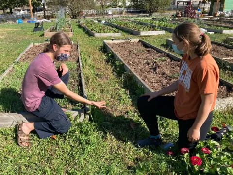 a couple of women planting flowers
