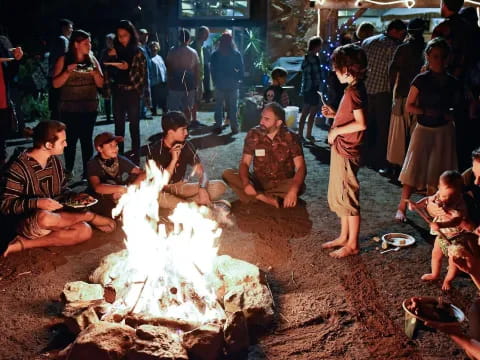 a group of people around a fire