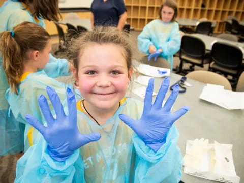 a girl with blue gloves