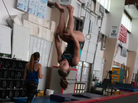 a person doing a handstand on a bar