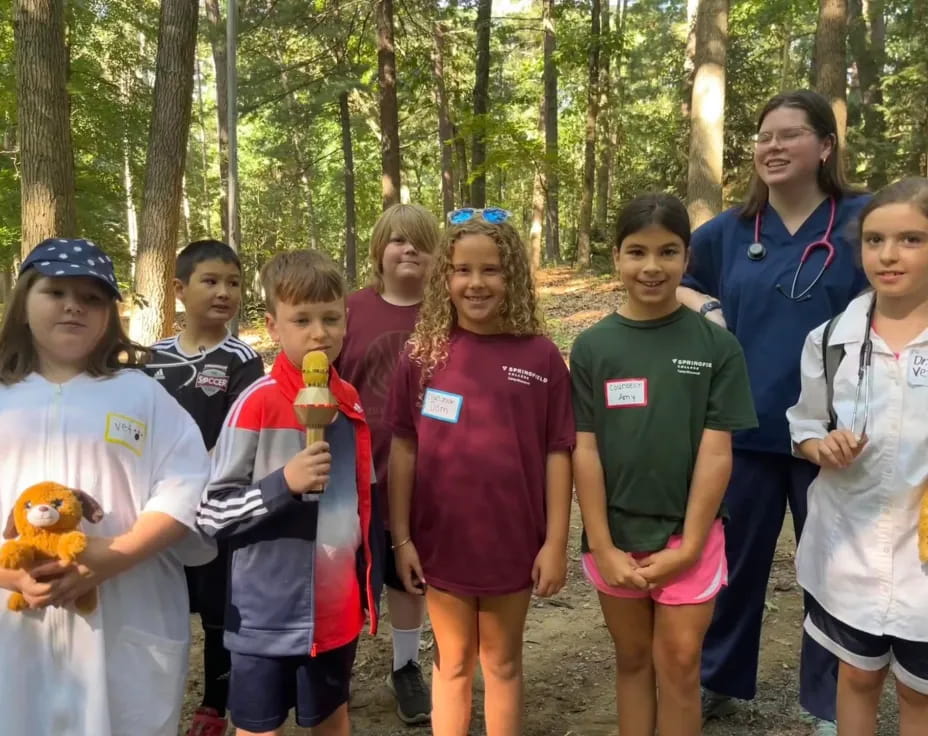 a group of people posing for a photo in the woods