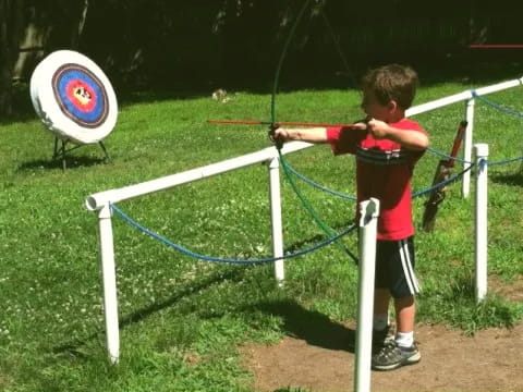 a boy playing with a frisbee