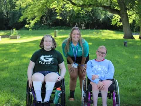 a group of people sitting in lawn chairs in a park