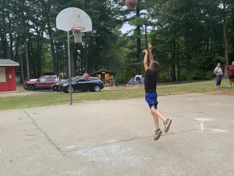 a boy jumping to dunk a basketball