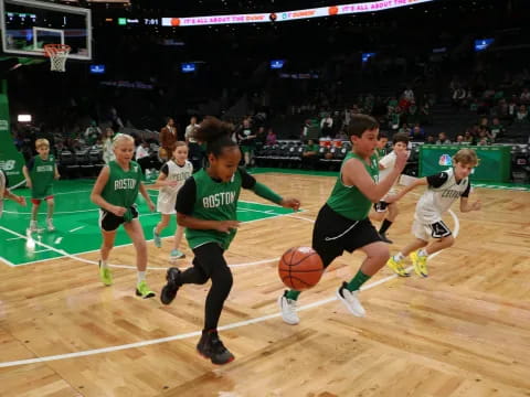 a group of people playing basketball