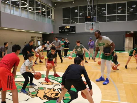 a group of people playing basketball