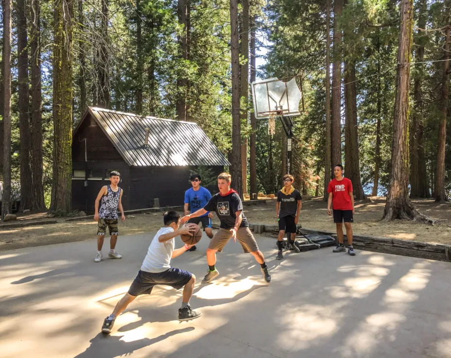 a group of people playing basketball