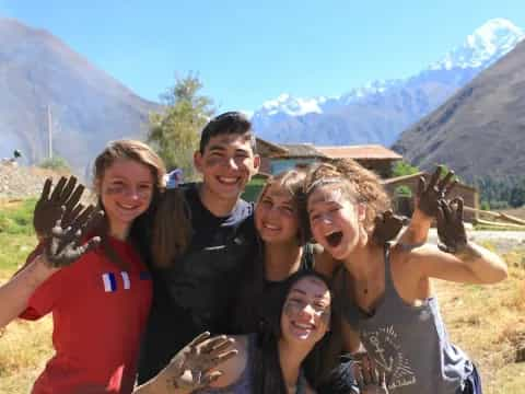 a group of people posing for a photo with their hands up