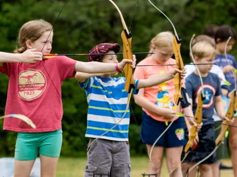 a group of kids playing with bows and arrows