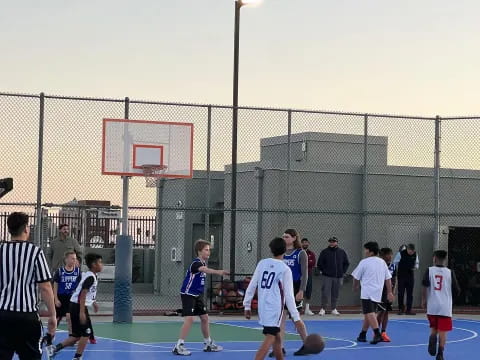 a group of people playing basketball