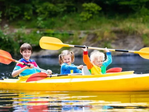 a group of kids in a canoe
