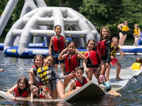 a group of people in life jackets in a pool