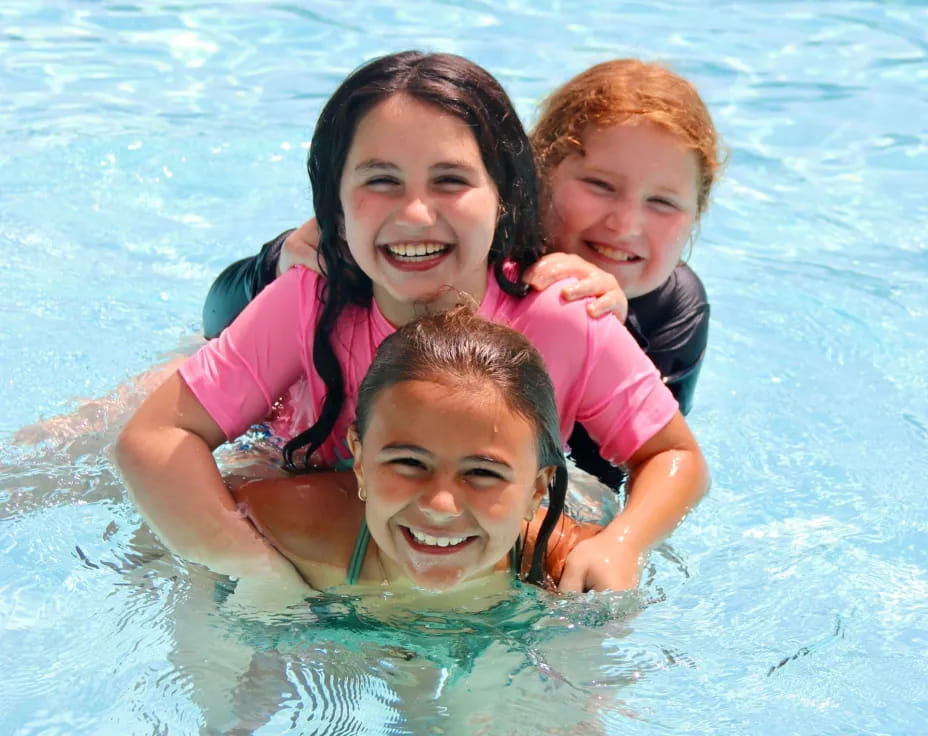 a person and two children in a pool