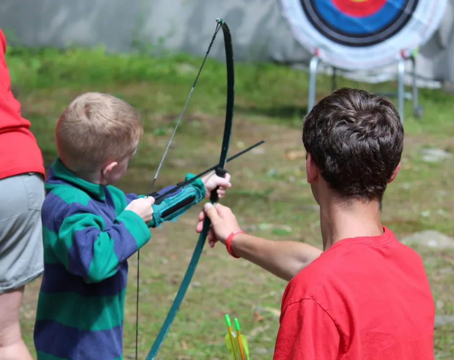 a couple of boys shooting bows