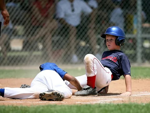 a baseball player sliding into home plate