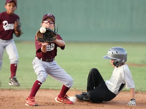 a group of kids playing baseball