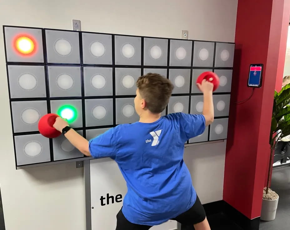 a boy holding boxing gloves