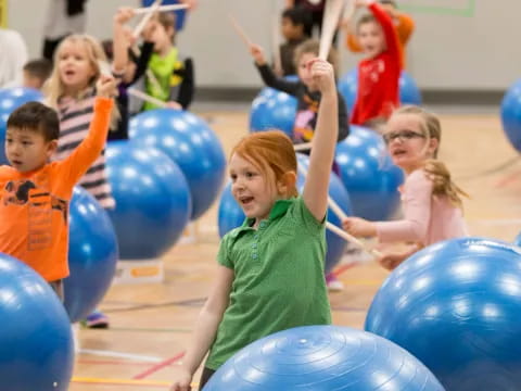 a group of children playing with balloons