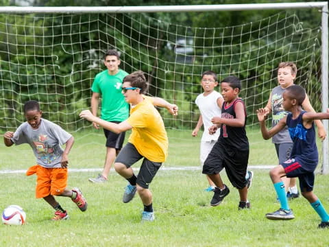 a group of kids playing football