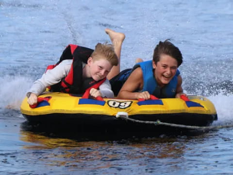 a man and a boy on a raft in the water