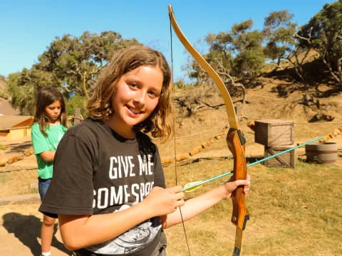 a girl holding a bow and arrow