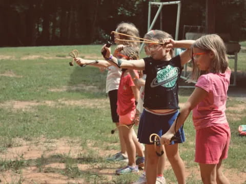 a group of children playing with bows and arrows