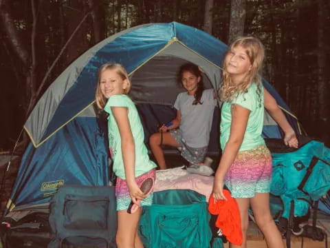 a group of girls standing under a tent