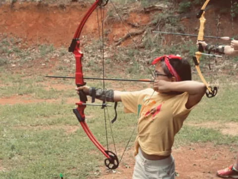 a person shooting a bow and arrow