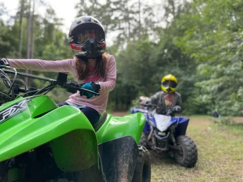 a group of people riding on lawn mowers