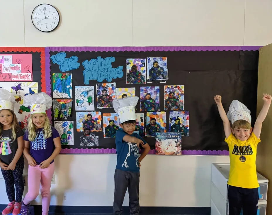 a group of children wearing paper hats