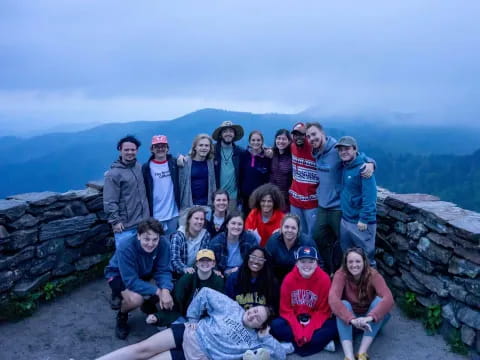 a group of people posing for a photo on a mountain