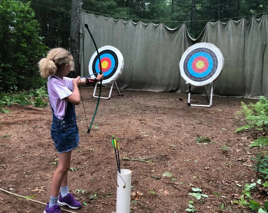 a couple of kids shooting target archery