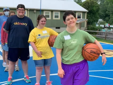 a group of people holding a basketball