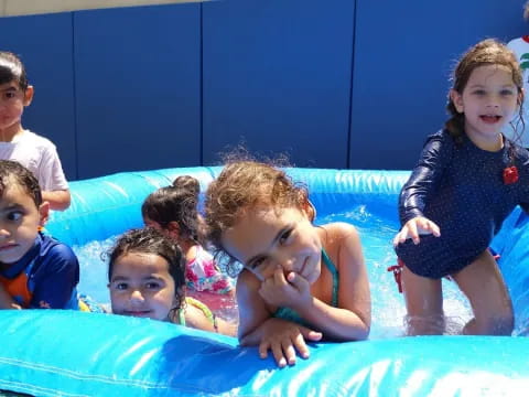 a group of children in a pool