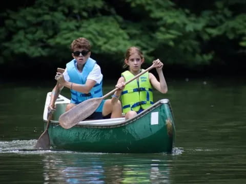 a man and a woman in a canoe on a river