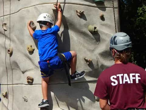 a person climbing a rock wall