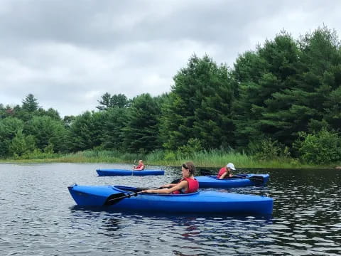 a group of people in kayaks on a lake