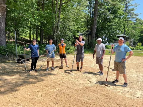 a group of people holding sticks