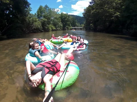 a group of people in a row boat on a river